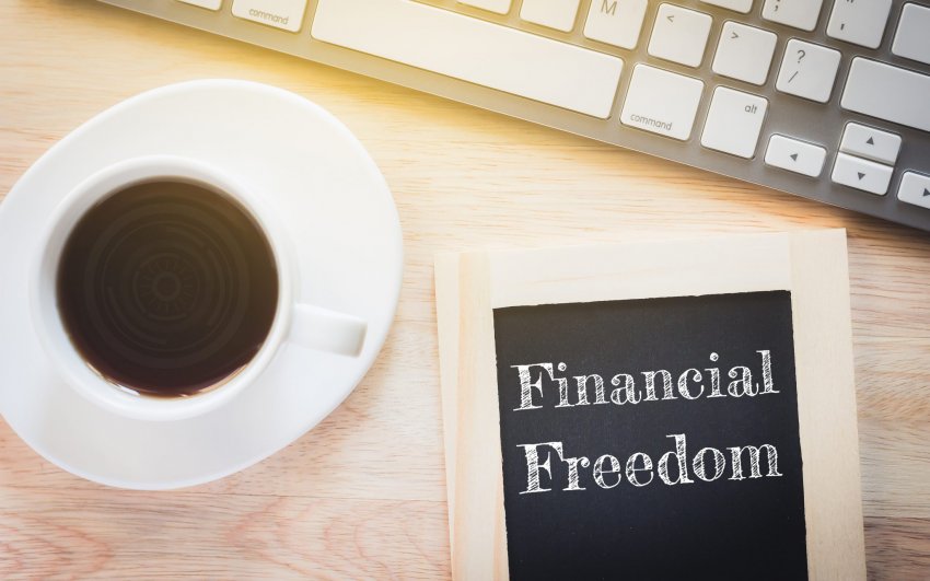 financial freedom on desk with coffee